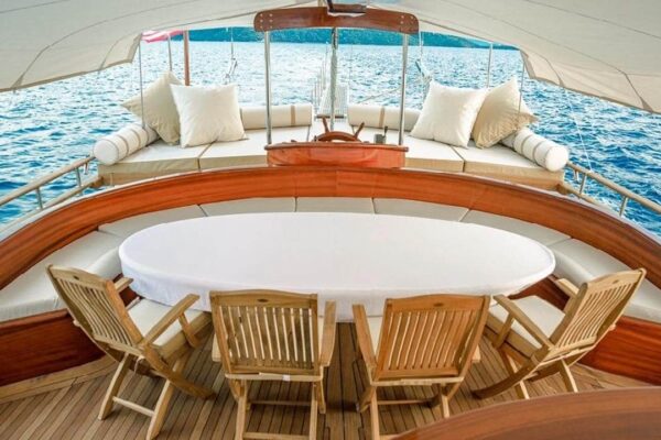 wicked-felina-gulet-photo17 Luxurious gulet yacht deck in Turkey, featuring spacious seating, wooden furniture, and ocean views for premium gulet charter experiences.